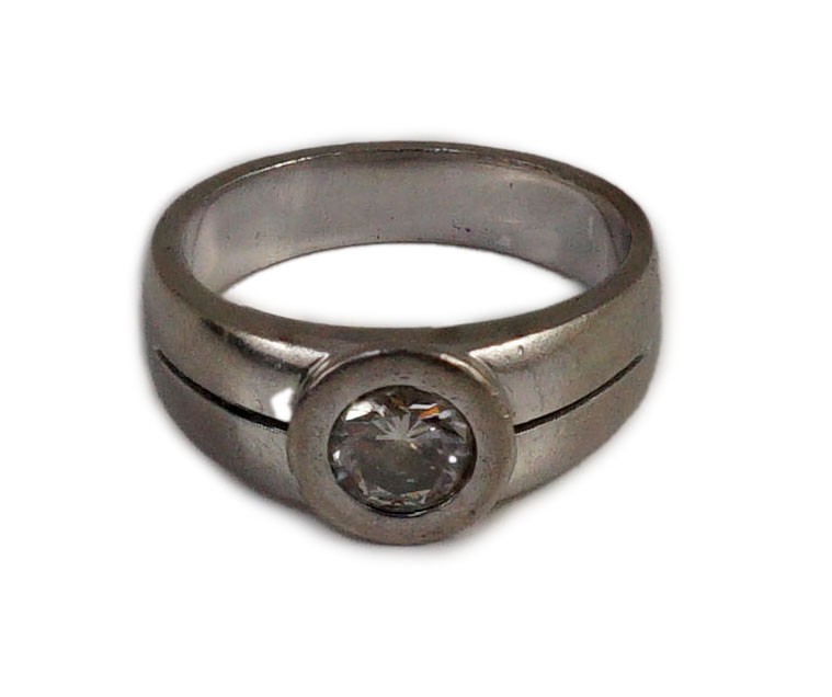 A modern 18k white gold and collet set solitaire diamond ring